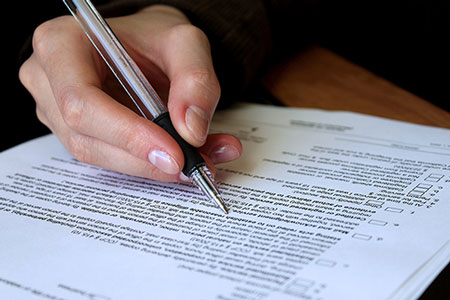 Photo of banking legal document being signed with a pen