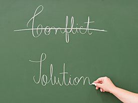 photo of chalkboard crossing out conflict and replacing with resolution