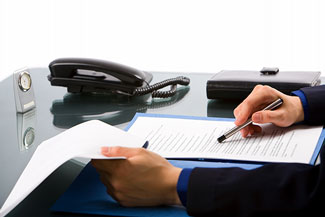 desk of corporate lawyer reviewing legal agreement